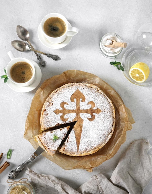 Tarta de santiago and coffee cups spanish almond cake top view morning concept