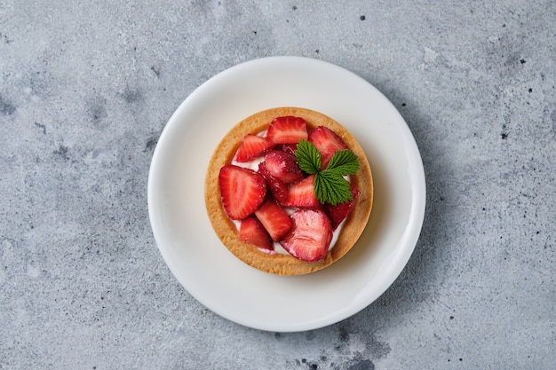 Tartlets with caramel, berries and cream cheese. A beautiful and delicious dessert.