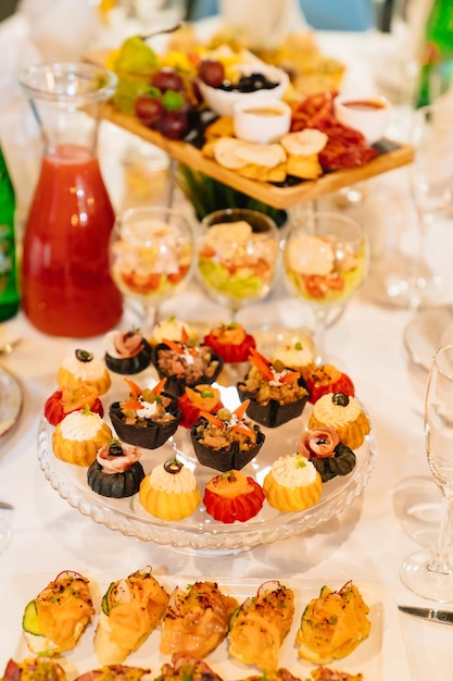 Tartlets with salads snacks and drinks convenient serving of snacks for the buffet catering for the holiday