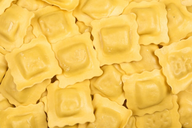 Tasted italian food Quantity of ravioli pasta as a background Top view style