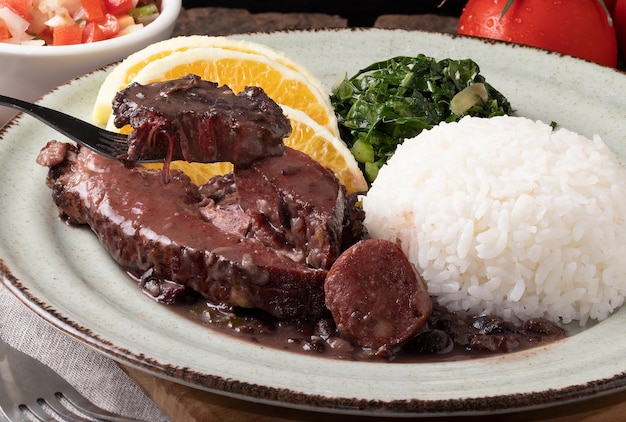 Tasting Brazilian traditional food feijoada