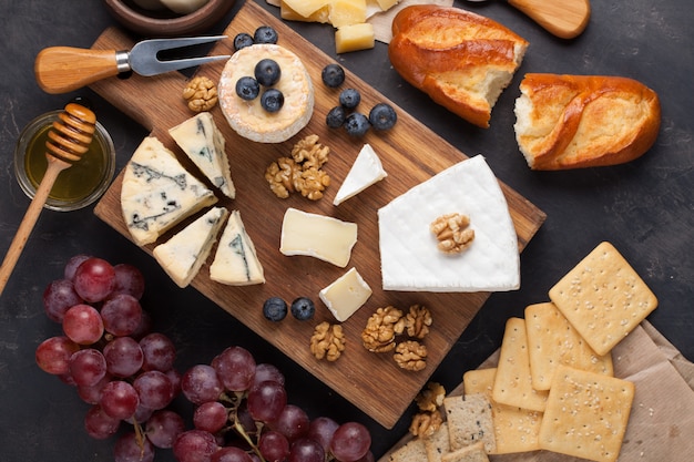 Tasting cheese dish on a dark stone plate.