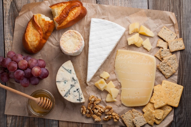 Tasting cheese dish on a wooden background.