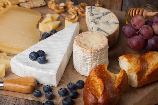 Tasting cheese dish on a wooden background.