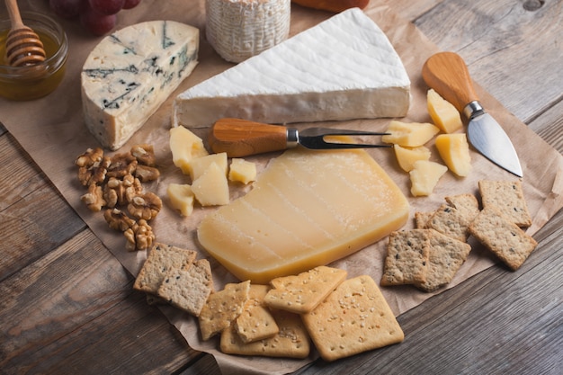 Tasting cheese dish on a wooden background.