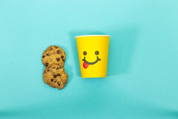 Tasting Food Face With Tongue Out and Chocolate Chip Cookies isolated on blue background