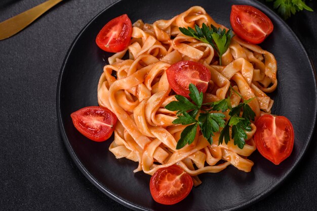 Tasty appetizing pasta tagliatelle spaghetti with tomato sauce and parmesan