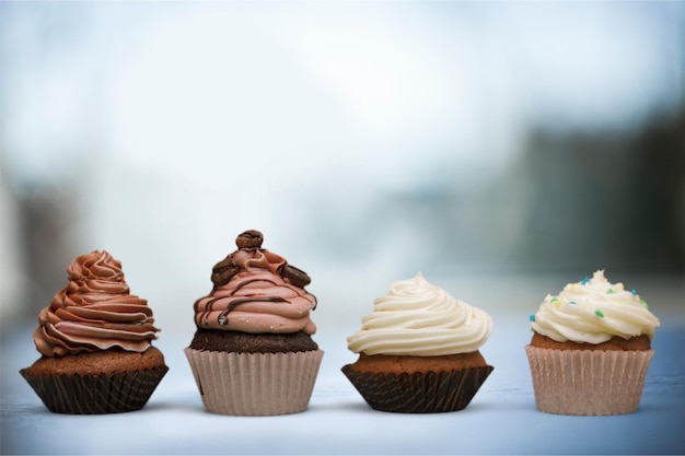 Tasty baked cupcakes on wooden table