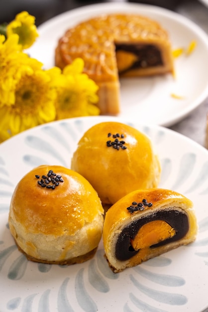 Tasty baked egg yolk pastry moon cake for MidAutumn Festival on bright cement table background Chinese traditional food concept close up copy space