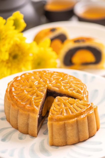 Tasty baked egg yolk pastry moon cake for MidAutumn Festival on bright cement table background Chinese traditional food concept close up copy space