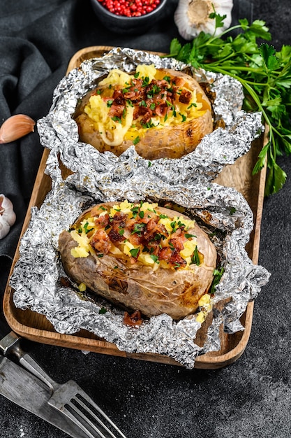 Tasty baked potato topped with cheddar cheese garlic and parsley