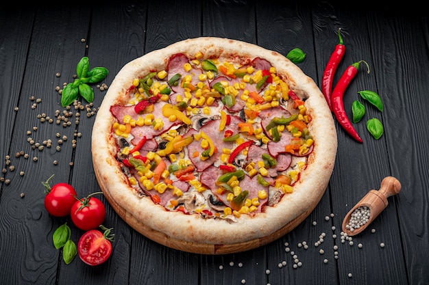 Tasty and big pizza with different types of meat Pizza with different types of ingredients sweet paprika and mushrooms