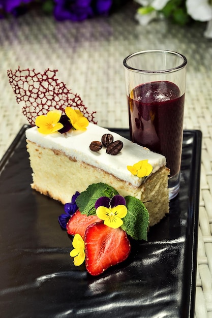 Tasty biscuit cake with butter cream decorated by strawberry