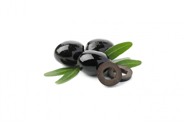 Tasty black olives and leaves isolated on white, close up