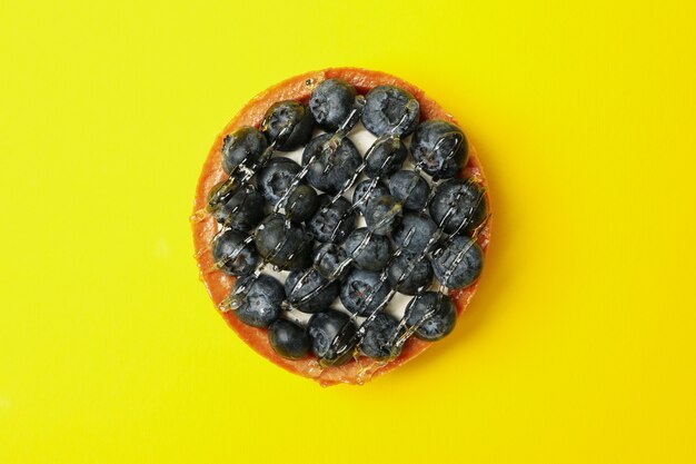 Tasty blueberry pie on yellow, top view