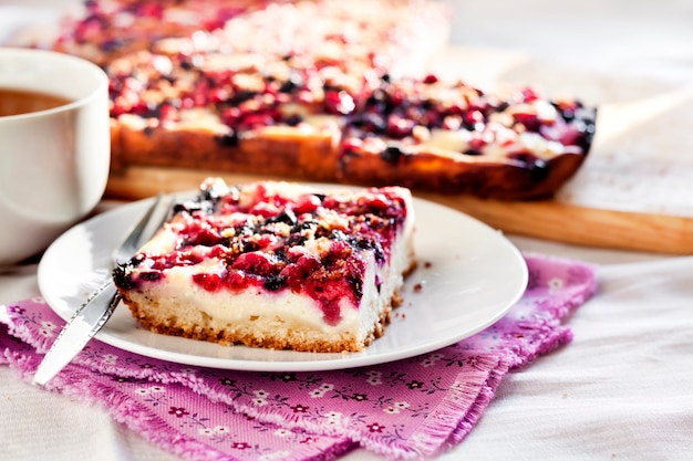 Tasty breakfast. Delicious pie with berries and cottage cheese an a cup of tea