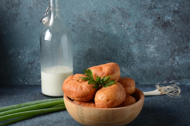 Tasty breakfast rustic style Stuffed Buns Pirozhki milk with green onions