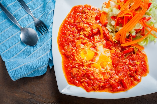 Tasty Breakfast Shakshuka in white plate