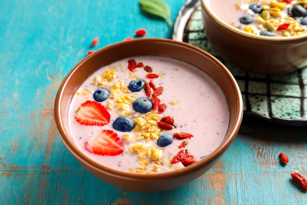 Tasty breakfast with goji berries in bowl on table