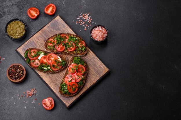 Tasty bruschetta with tomatoes mozzarella basil spices and herbs