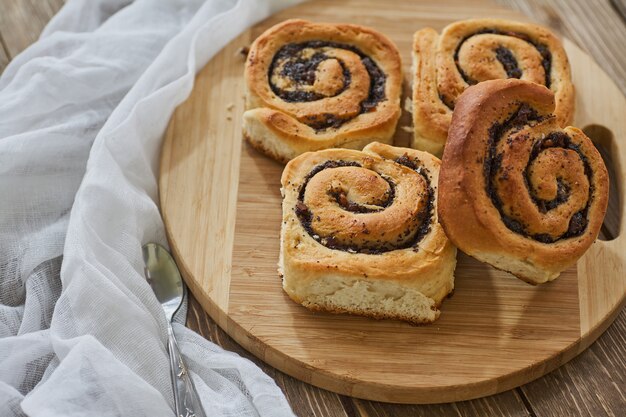 Tasty buns with raisins on a brown rustic wooden table. fresh bakery. breakfast. bread. top view