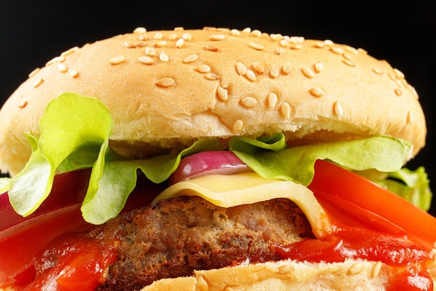 Tasty burger closeup Burger with tomatoes greens onions and meat Classic Burger close up