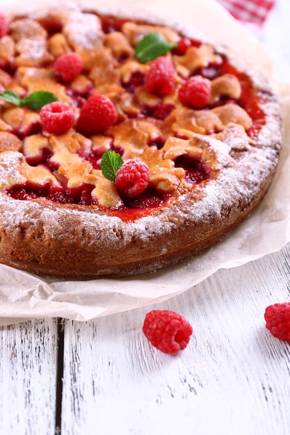 Tasty cake with berries on table closeup