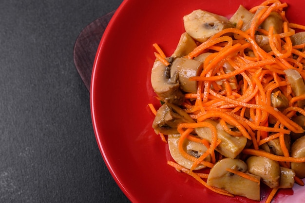 Tasty canned mushrooms on a red plate with spices and herbs