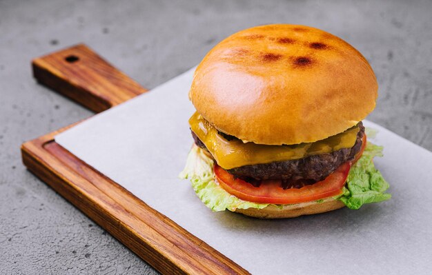 Tasty cheeseburger with lettuce cheese and tomato