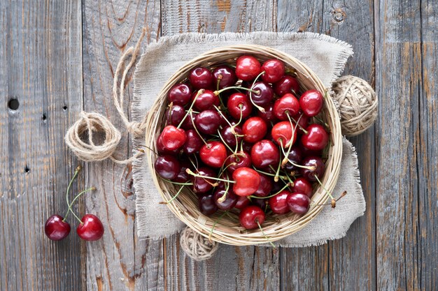 Tasty cherry, flat lay on rustic wood