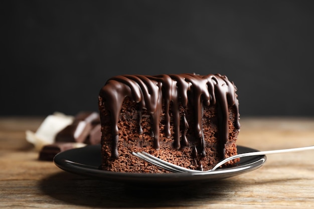 Tasty chocolate cake served on wooden table