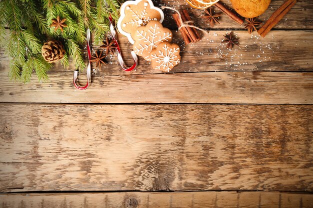 Tasty Christmas homemade cookies and decor on wooden background