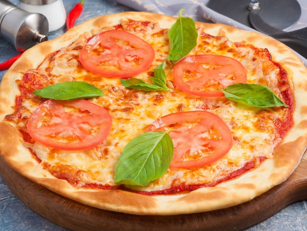 Tasty classic pizza Margarita decorated with Basil