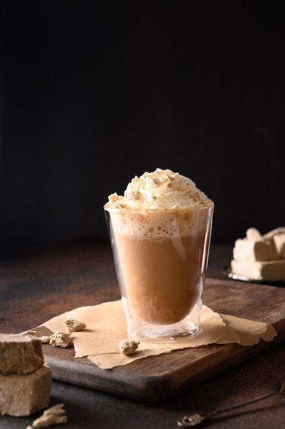 Tasty coffee latte with halva in glass cup