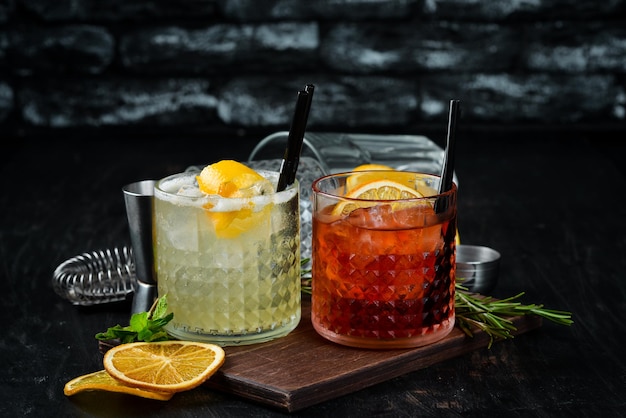 Tasty colored alcoholic cocktails On a wooden background Top view Free copy space