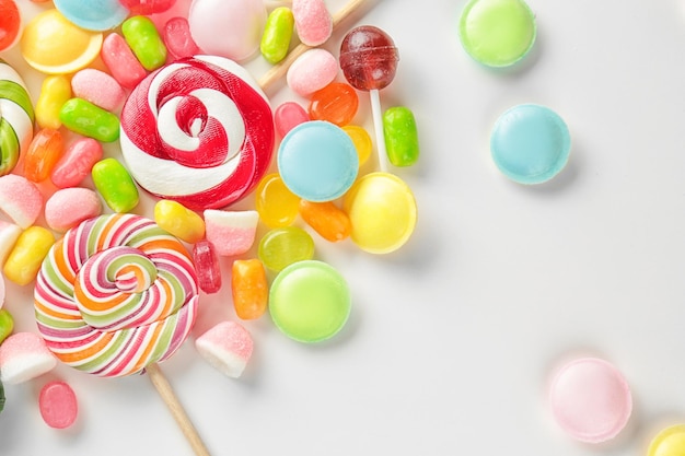 Tasty colorful candies on white background