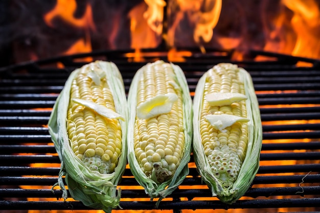 Tasty corn on grill with butter and salt