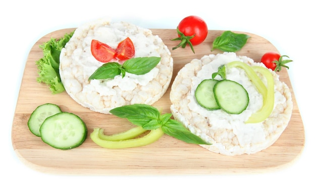 Tasty crispbreads with vegetables isolated on white