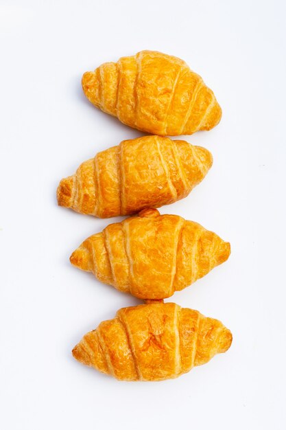 Tasty croissants on white surface