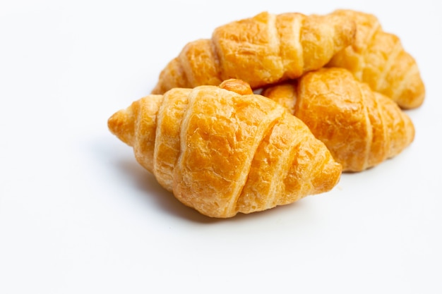 Tasty croissants on white surface