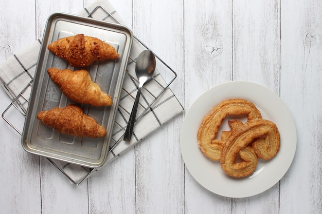 Tasty croissants on wooden background