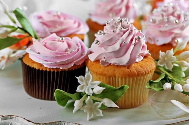 Tasty cupcakes on plate closeup