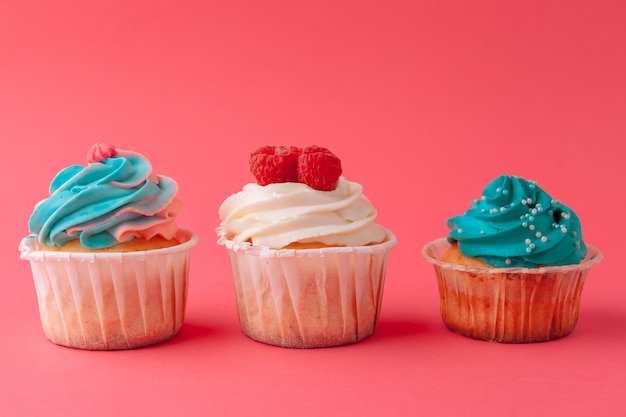 Tasty cupcakes sweets on pink close up