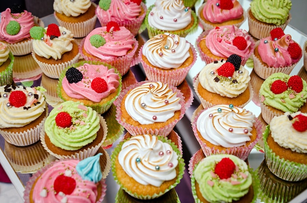 Tasty cupcakes on a white wooden table