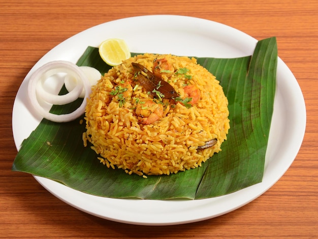 Tasty and delicious Prawns biryani served in a banana leaf selective focus