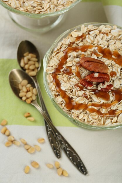 Tasty dessert with oat flakes and honey on table