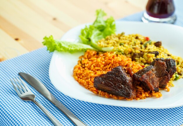 Tasty dish of roast beef with rice and salad leaves