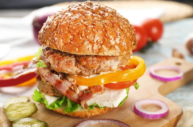 Tasty double burger on wooden board closeup