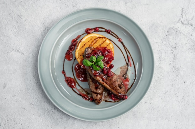 Tasty duck breast with orange and berries