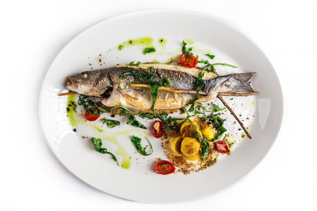 Tasty fish and vegetables on a white plate